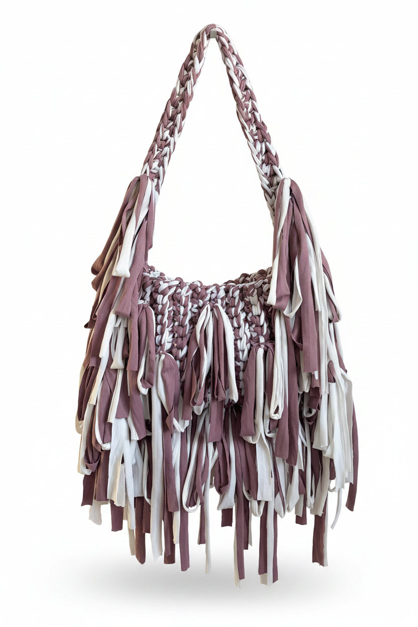 A fringed shoulder bag made from mauve and white t shirt yarn